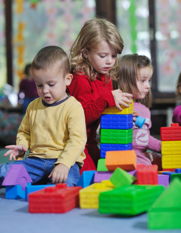 2-year-old children playing with blocks.