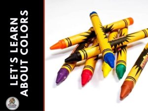 Crayons dumped out of a box to help a child learn about colors.