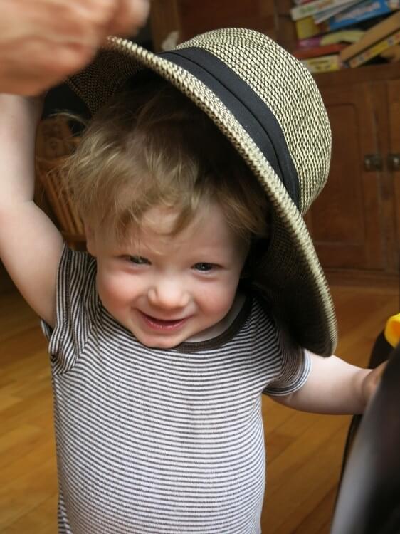 Little boy using auditory skills to play.