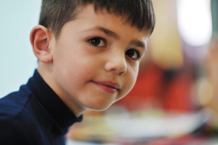 A young boy is learning French in school.